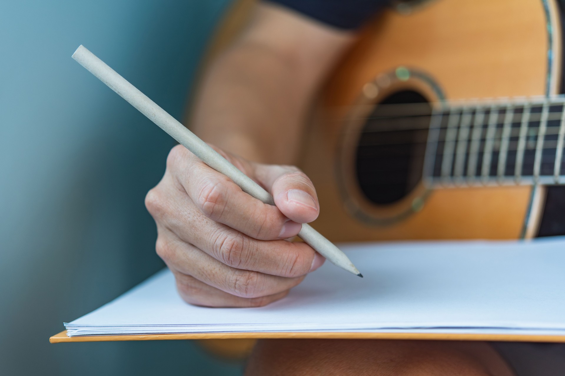 Songwriter Composing Music with Guitar